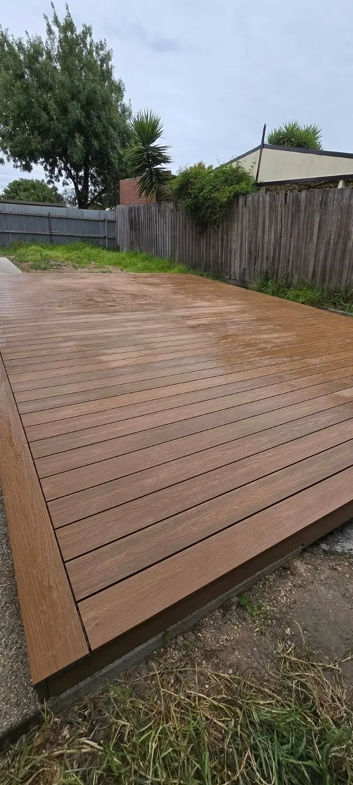 Large composite deck built across a levelled backyard