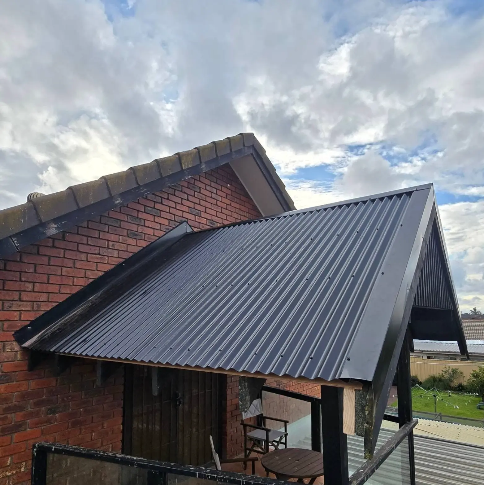 New Colorbond verandah roof and flashing on a brick home